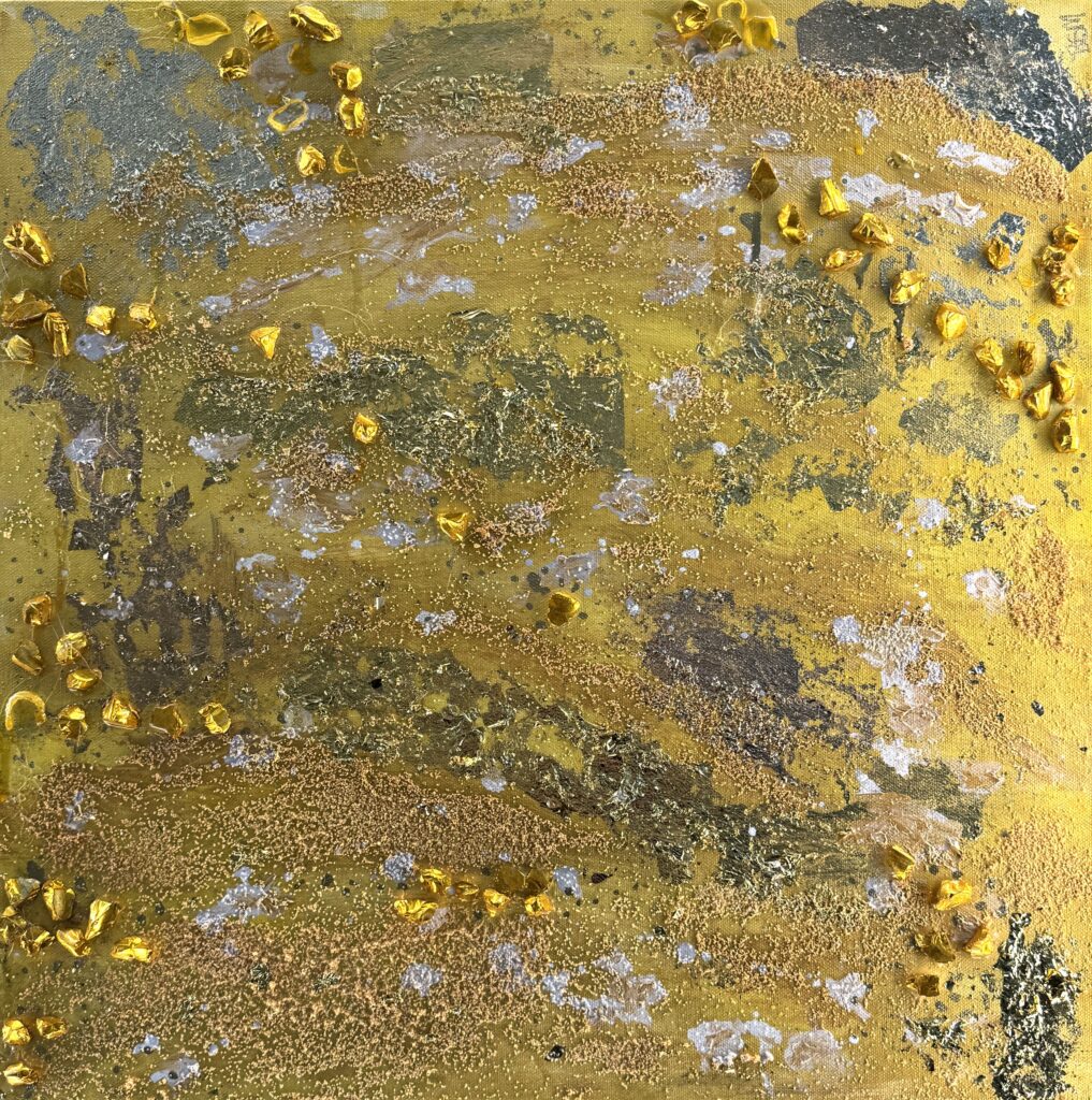 Gold Land (2026) — Mixed Media, 24"×24" — Belena Stuart Marquez Abstract mixed‑media artwork with a dominant golden‑yellow surface layered with textured materials. Metallic gold elements, granular particles, and patches of darker tones create depth and an organic, mineral‑like appearance. Subtle white and silvery highlights add contrast. A small “BSM” signature appears in the lower right corner.